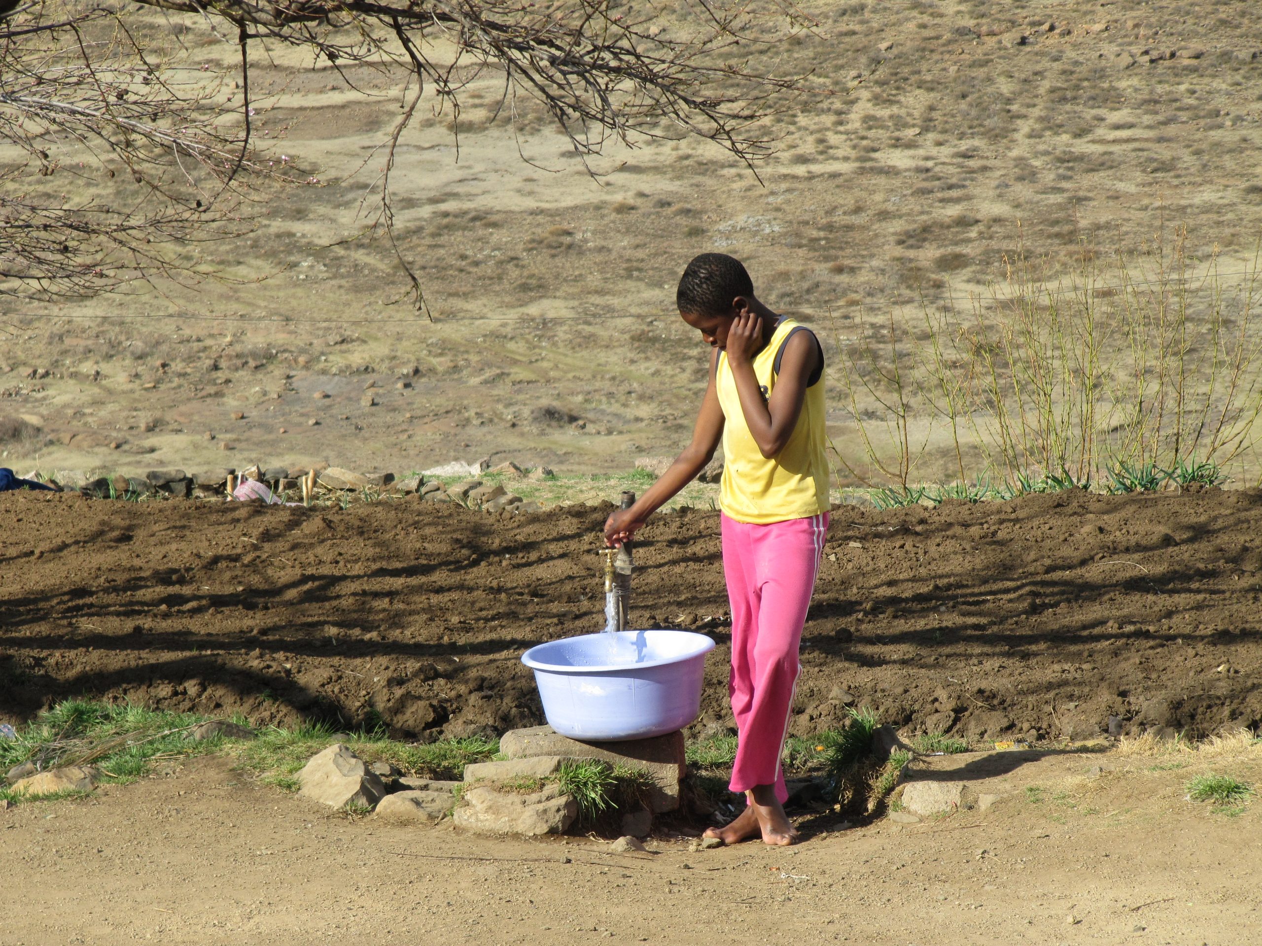 girl getting water in Lesotho