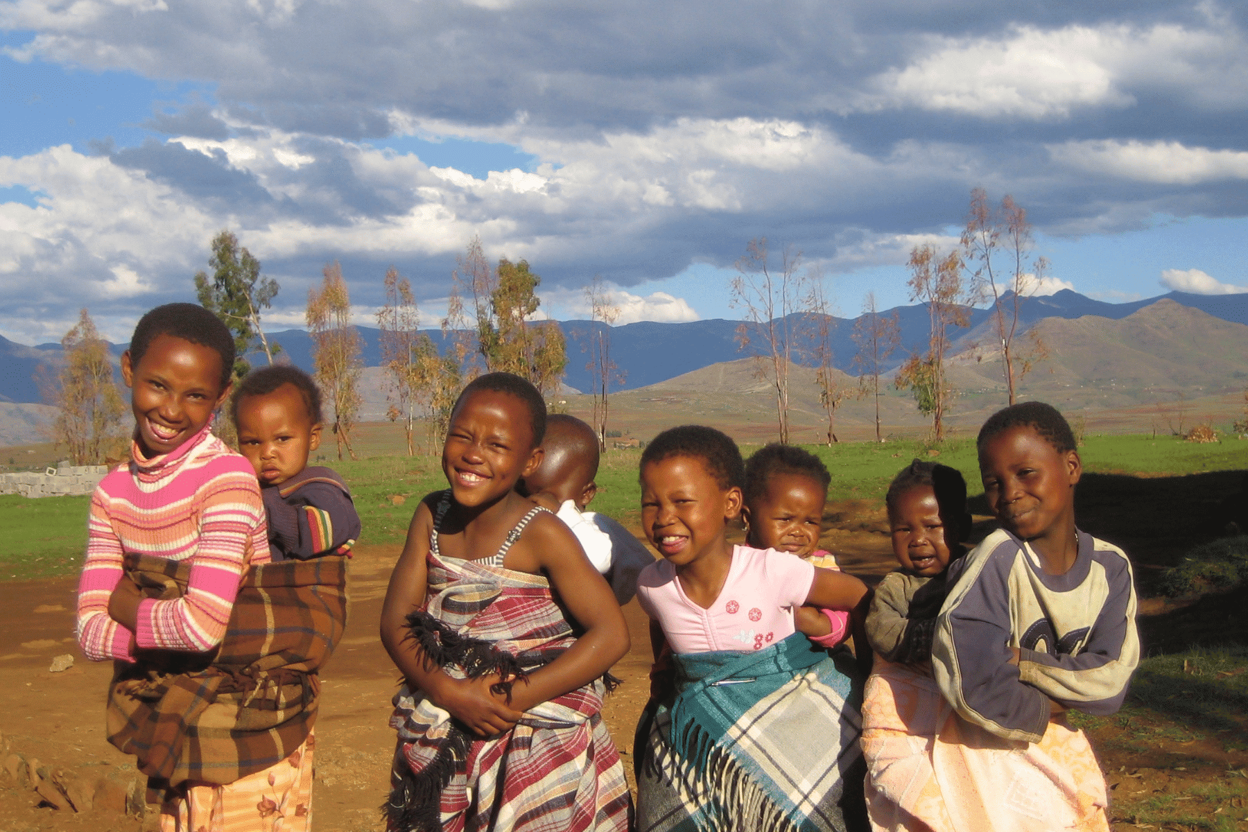 Untitled design (68) (1) young girls in lesotho, with siblings