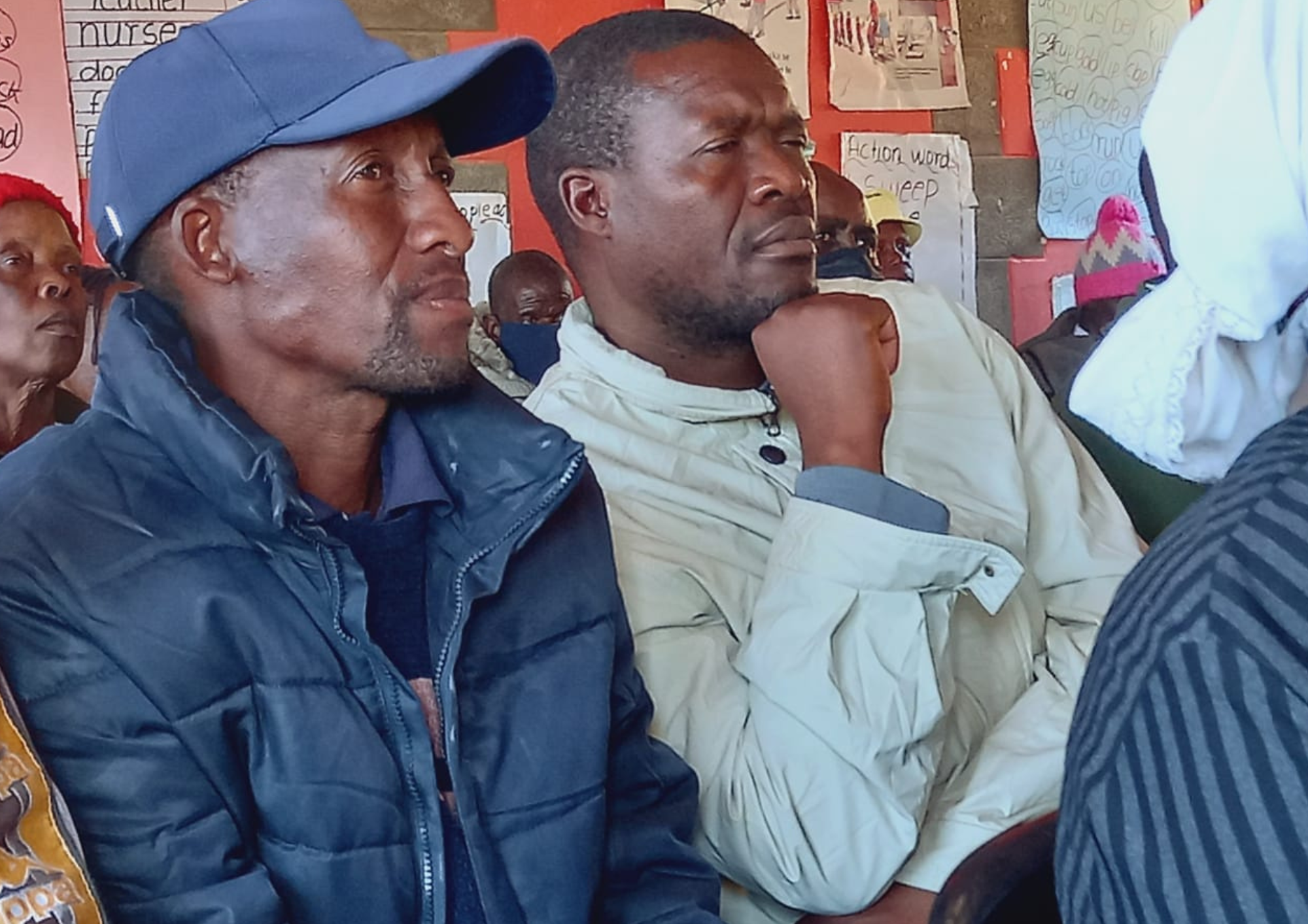 men sitting in a training session